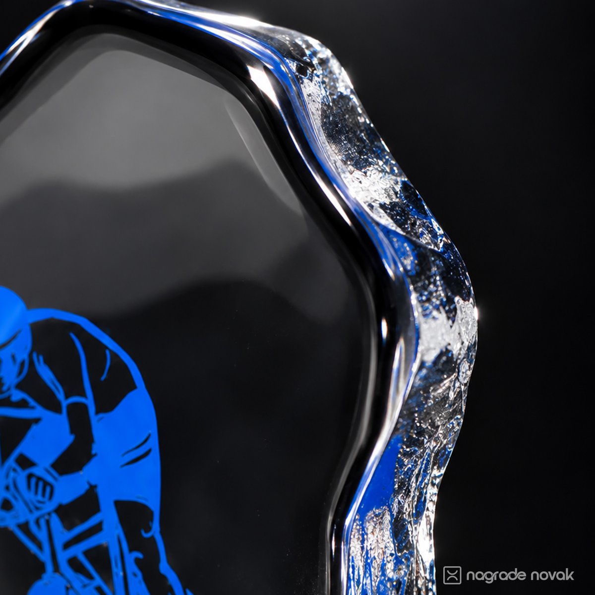 Detail of the textured, ice-like glass edge with part of the blue cyclist motif