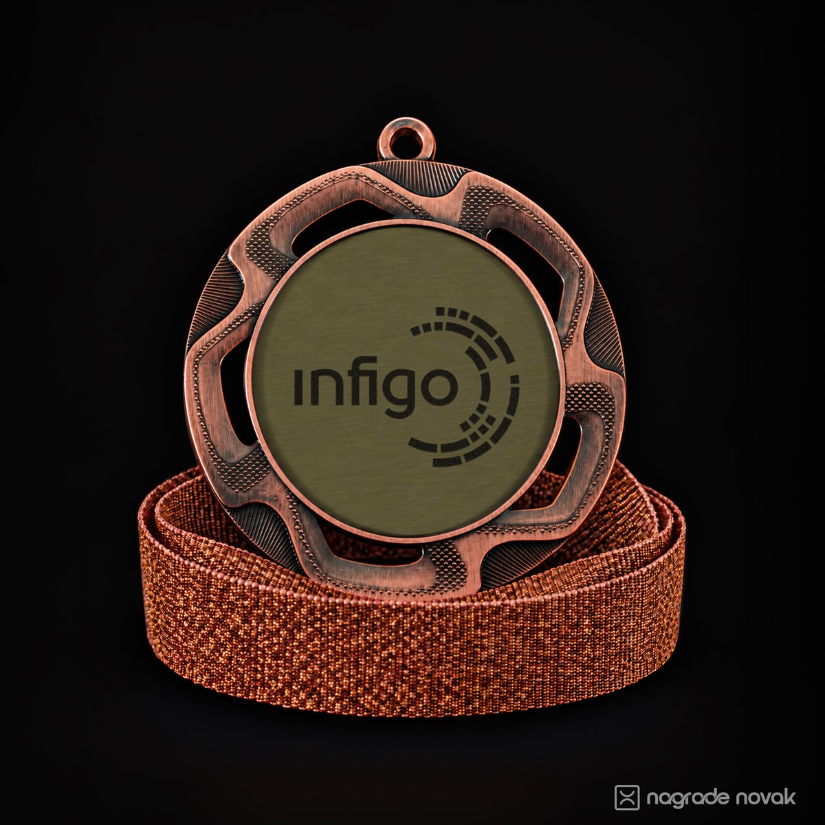 Bronze medal with an openwork border and a brushed gold insert showing the black Infigo logo, standing on a coiled copper glitter ribbon on a dark background