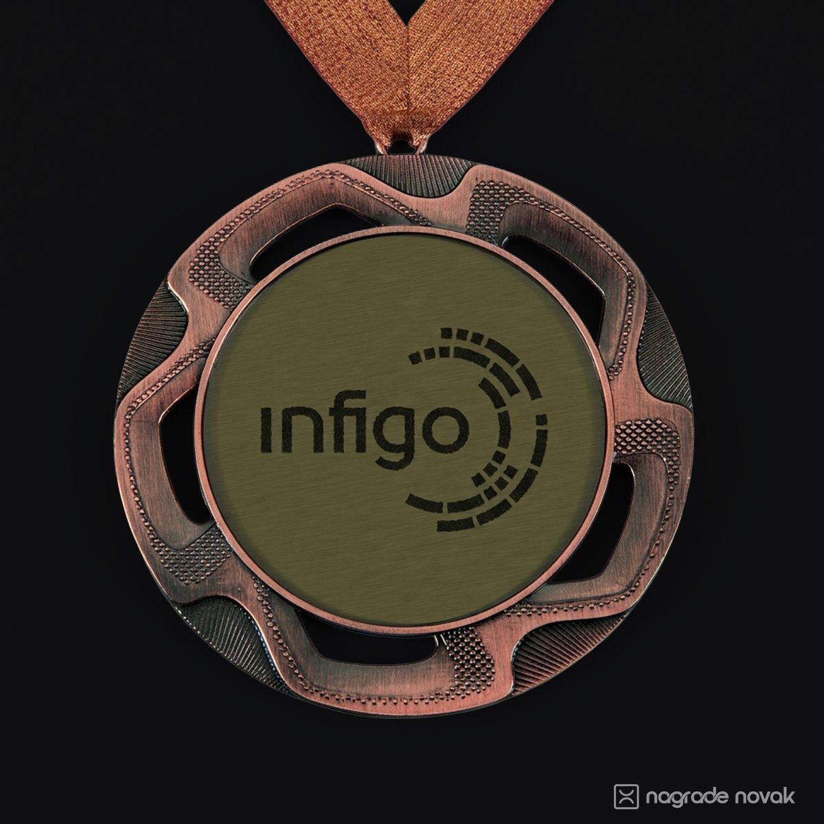 Close-up of a bronze medal with a brushed gold insert showing the black Infigo logo, hanging from a copper glitter ribbon on a dark background