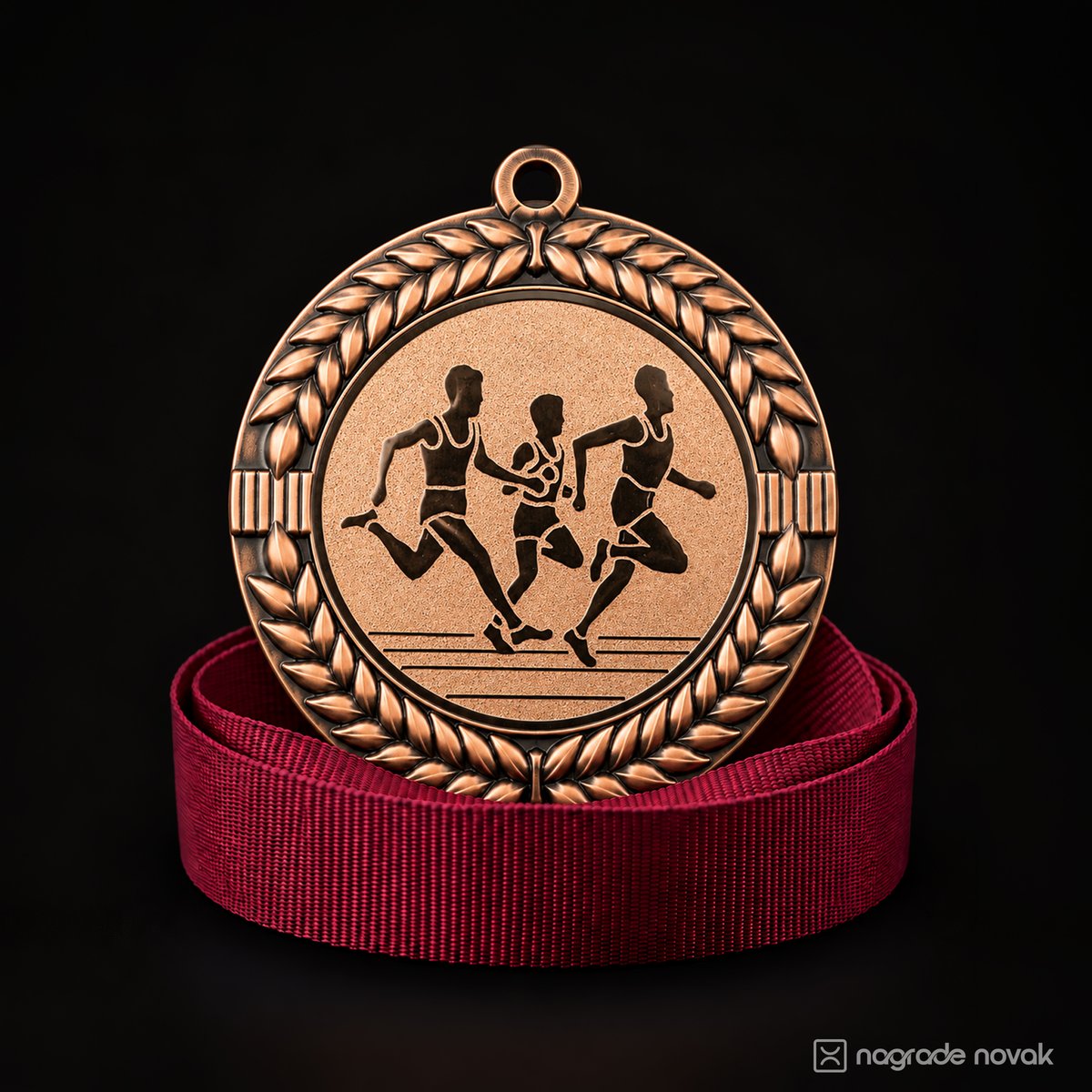 Bronze medal with a laurel wreath and a stylised group of three runners, resting on a coiled maroon ribbon, on a dark background
