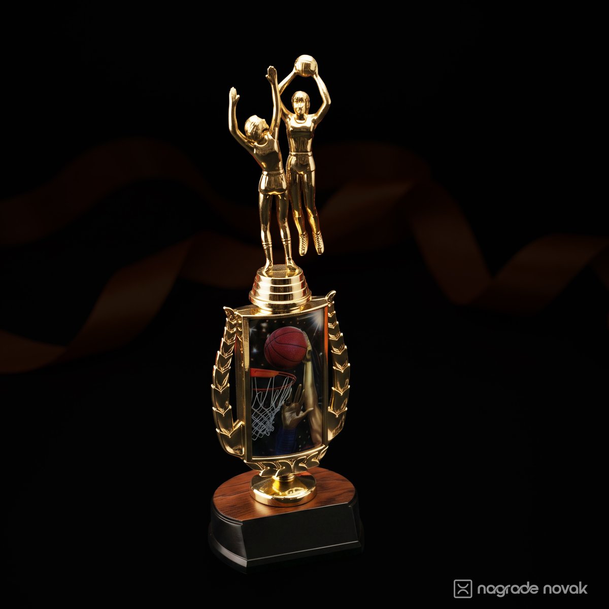 Gold basketball figurine trophy with two players on a decorated column and black base, with an orange ribbon on a dark background