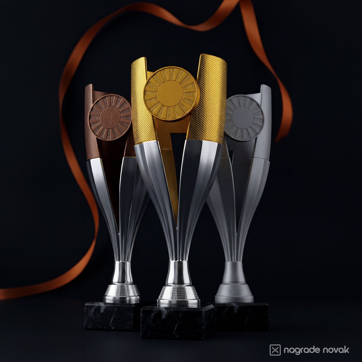 Three tall trophies in bronze, gold and silver on black marble bases, with an orange ribbon