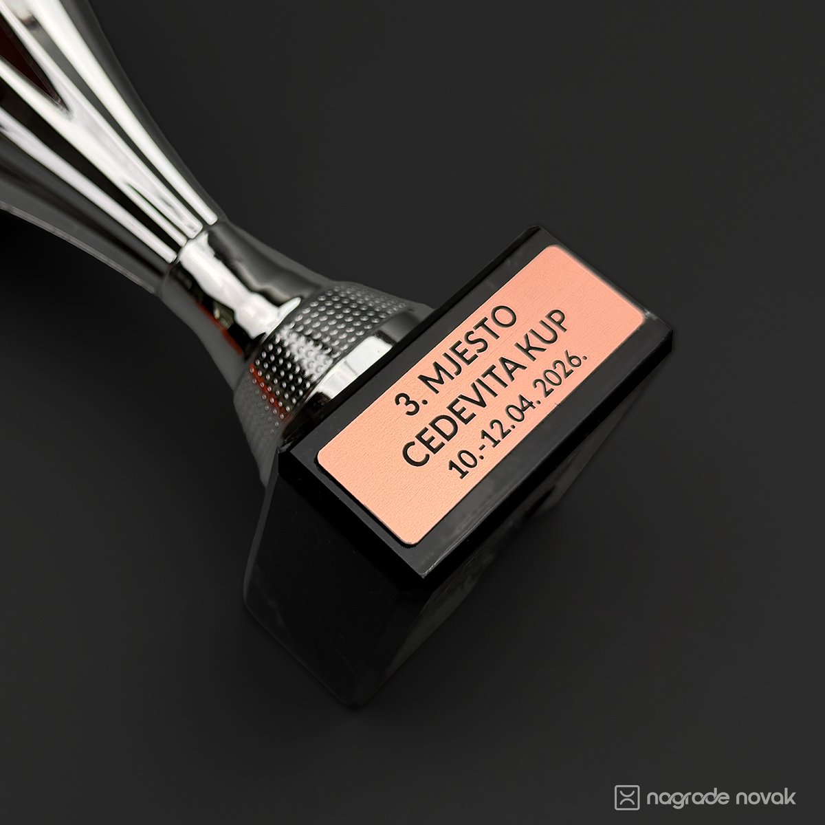 Close-up of a trophy base with a copper-coloured engraved plate reading 3rd place, Cedevita Cup, 10.-12.04.2026