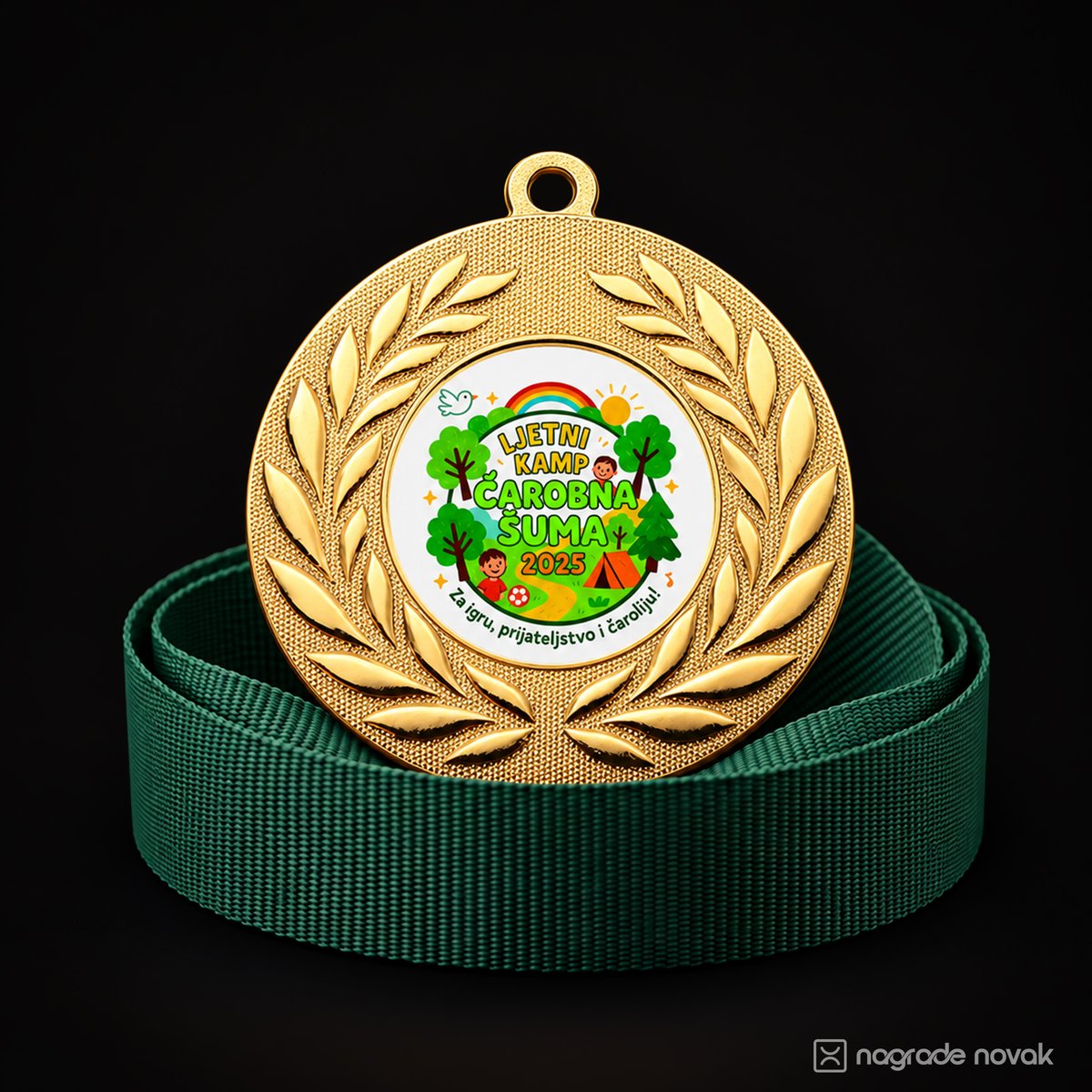 Gold medal with a laurel wreath and a colourful Magic Forest Summer Camp 2025 insert, resting on a dark green ribbon