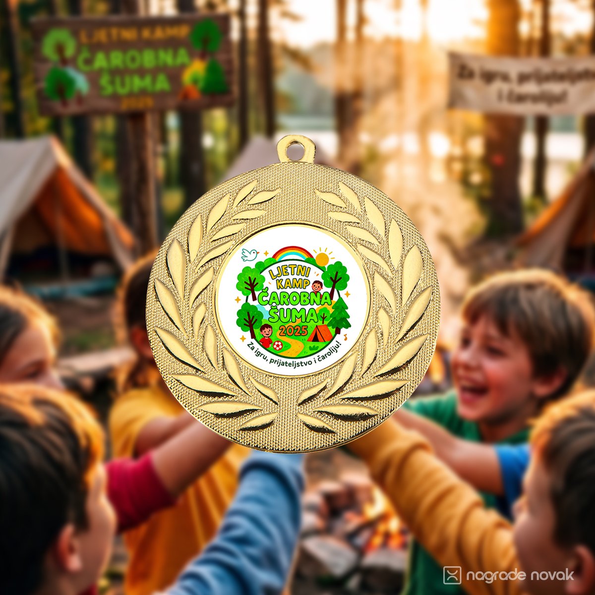 Gold medal with the camp insert in the foreground, with children gathered in a sunlit forest camp behind it