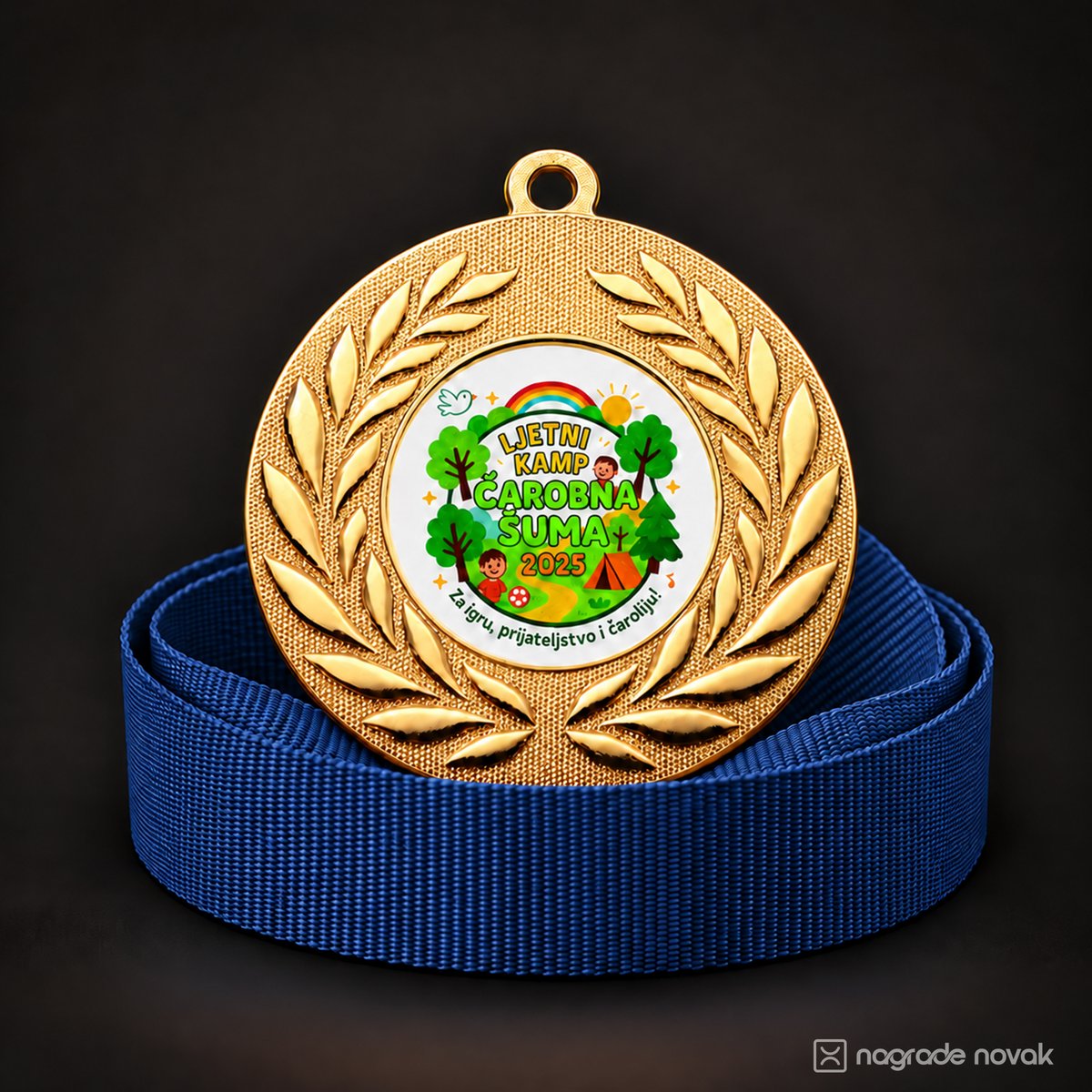 Gold medal with a laurel wreath and the colourful camp insert on a coiled blue ribbon, on a dark background