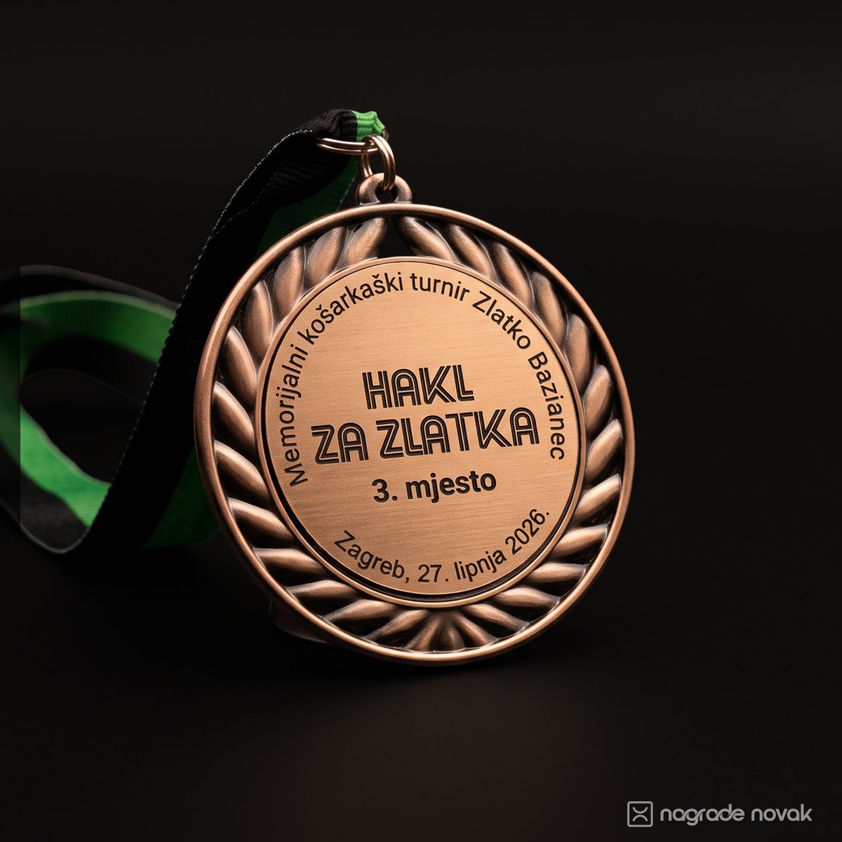 Bronze medal with a relief laurel wreath, engraved "HAKL ZA ZLATKA, 3. mjesto, Zagreb, 27. lipnja 2026.", hanging from a green and black ribbon